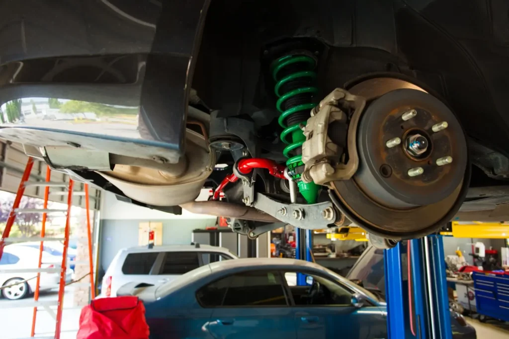 Subaru Shop with car on a lift and disc brake exposed