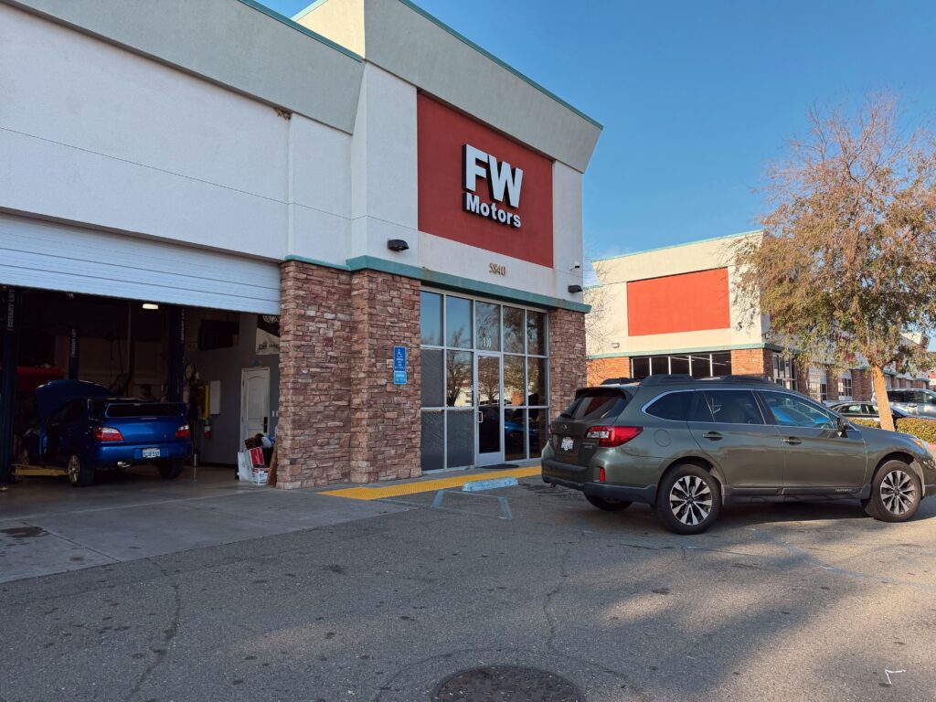 Subaru vehicle in front of repair garage
